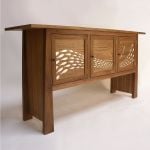 'Flow' sideboard in walnut with gilded fish. 